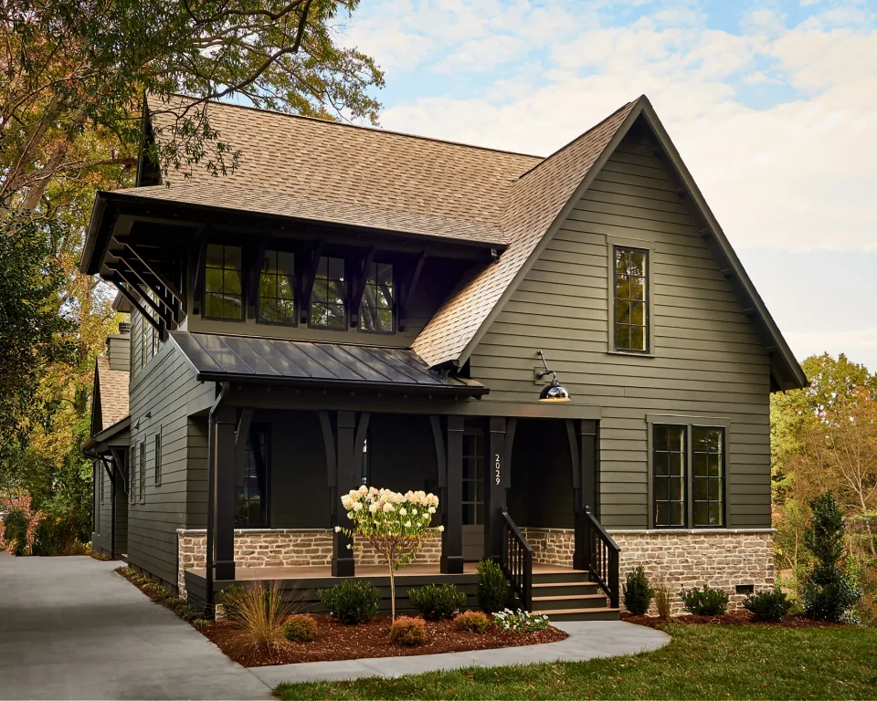 Home with painted siding, a covered entry and a steep gabled roof.